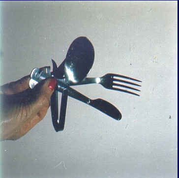 (2) mess utensil kit after PMB has taken effect (the single items of the kit have been bent one by one)